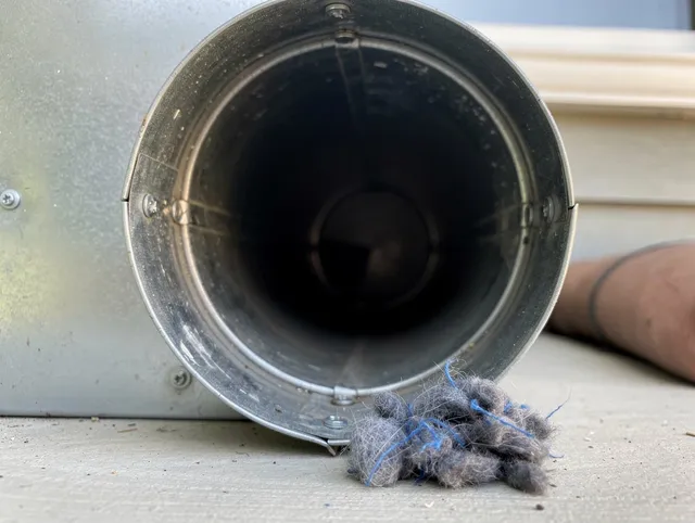 Cerritos Dryer Vent Cleaning technician using specialized equipment to clear severe dryer vent blockage in Cerritos